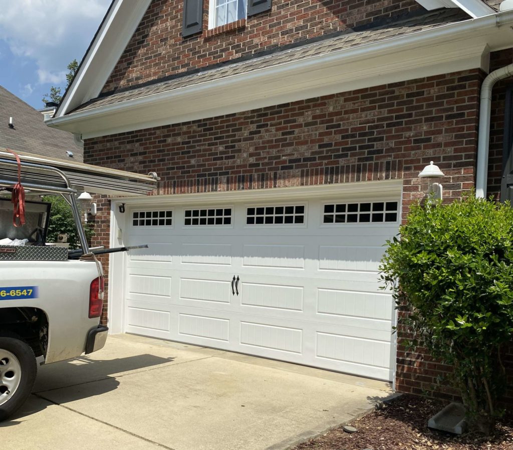 White traditional garage door with long panels