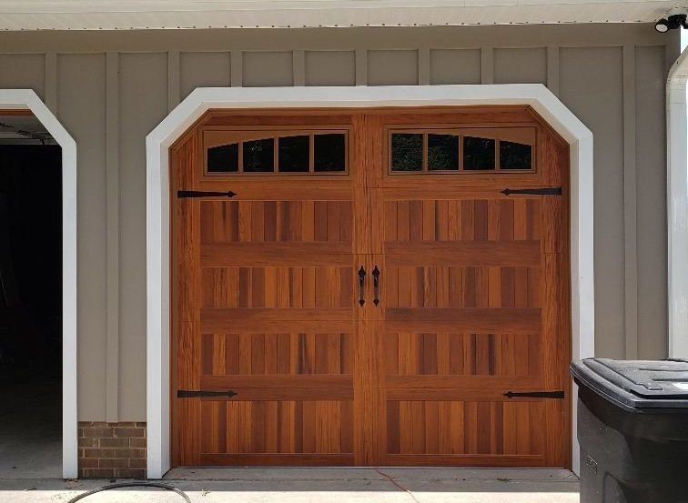 Faux wood carriage garage door with black handles 